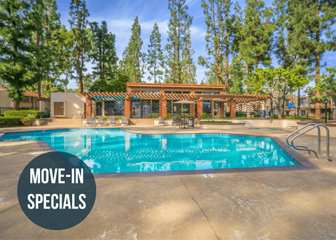 a large swimming pool with trees in the background and a sign that reads move in